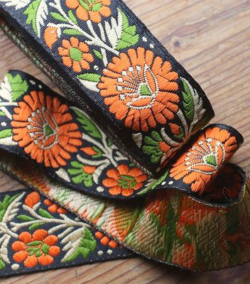 Dekorband 4 cm grönt - orange ringblommor