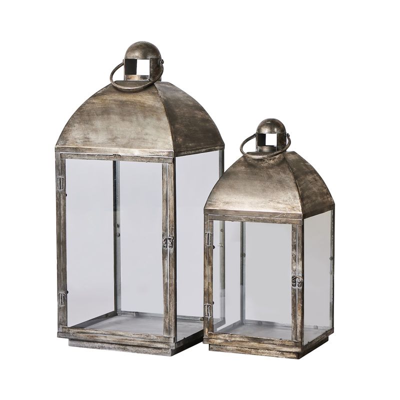 Set med två dekorativa metalllyktor i olika storlekar med glasväggar och antik finish.