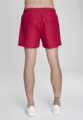 Red swim shorts with embroidered leaves
