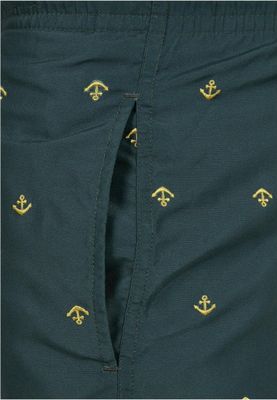 Dark green swimming shorts with golden anchors