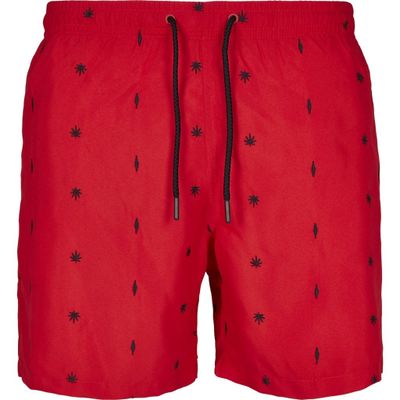 Red swim shorts with embroidered leaves