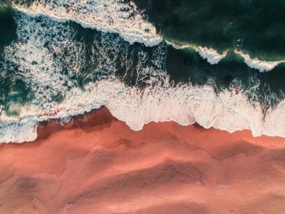 Vibrant Pink Sand And Foamy Teal Waves