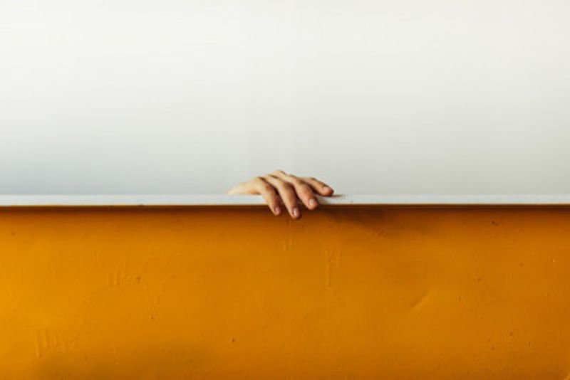 Human Hand Gripping The Top Edge