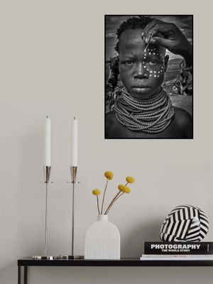 Painting the face of a karo tribe girl (Omo Valley-Ethiopia)