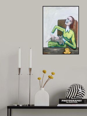 Lady tickling grey cat in chair