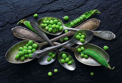 Vibrant Green Peas In A Vintage Spoon