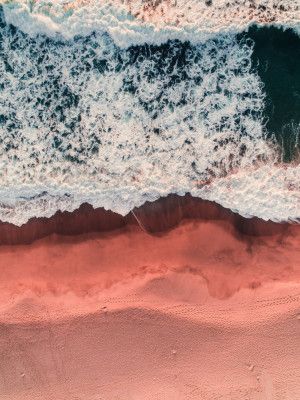 Waves Crashing On A Pink Sandy Beach