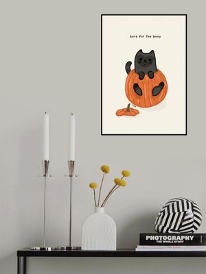 Black Cat Playfully Sitting In A Pumpkin
