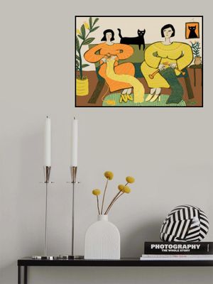 Women knitting on couch with black cat