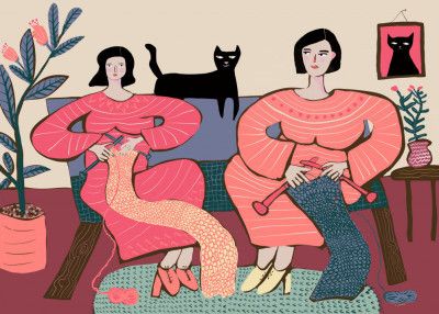 Women knitting on couch with black cat