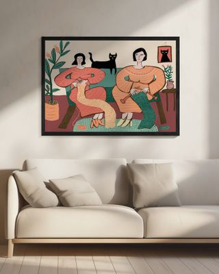 Women knitting on couch with black cat