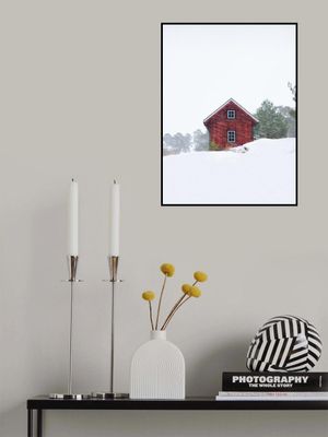 Old red house during snowstorm