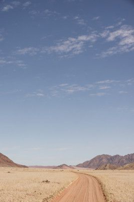 Vast Desert Road Under A Clear Blue Sky
