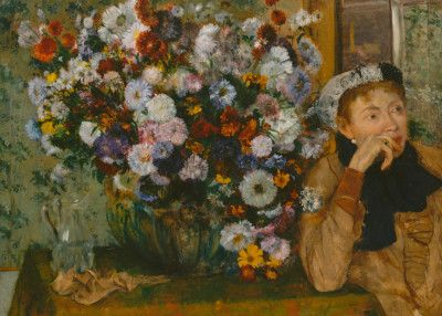 A Woman Seated Beside a Vase of Flowers