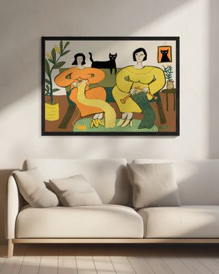 Women knitting on couch with black cat