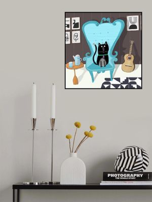 Cute Black Cat sitting on Blue Armchair by Artist Carla Daly