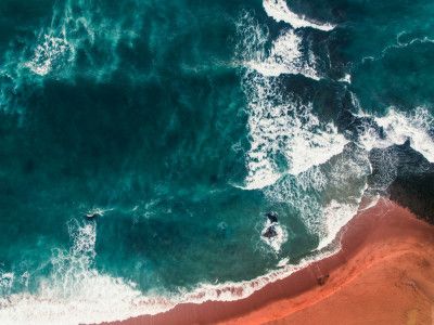 Ocean Waves Crashing Onto A Sandy Beach