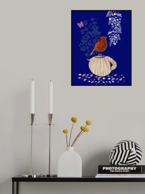 Red Bird Perched on a Striped Teapot