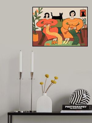 Women knitting on couch with black cat