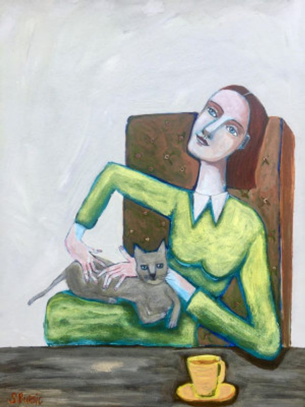 Lady tickling grey cat in chair