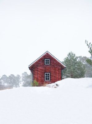 Old red house during snowstorm