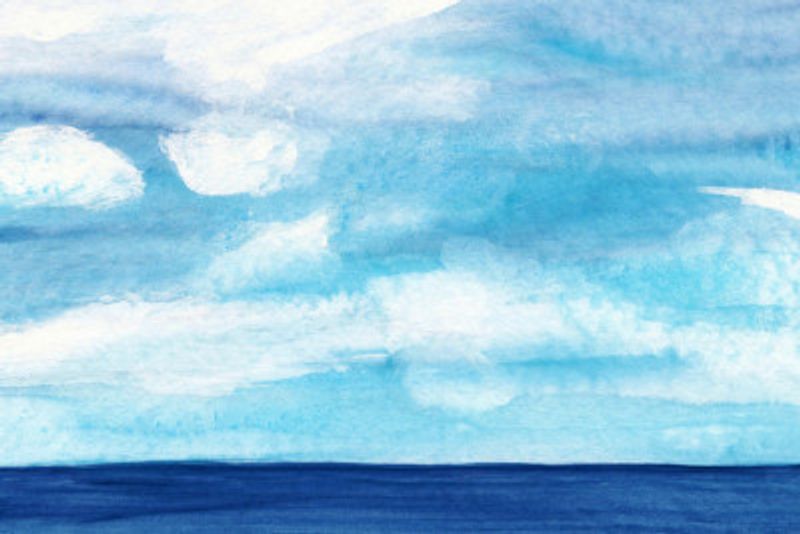 A Tranquil Blue Ocean with Cloudy Skies