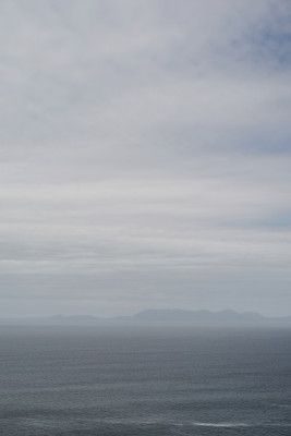 Tranquil Ocean And Distant Horizon Under A Clouded Sky