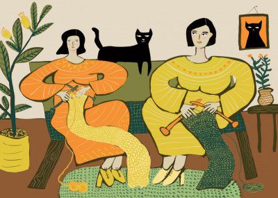 Women knitting on couch with black cat