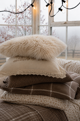 Fuzzy, natural-white pillowcase with long, soft, sheepskin-like pile