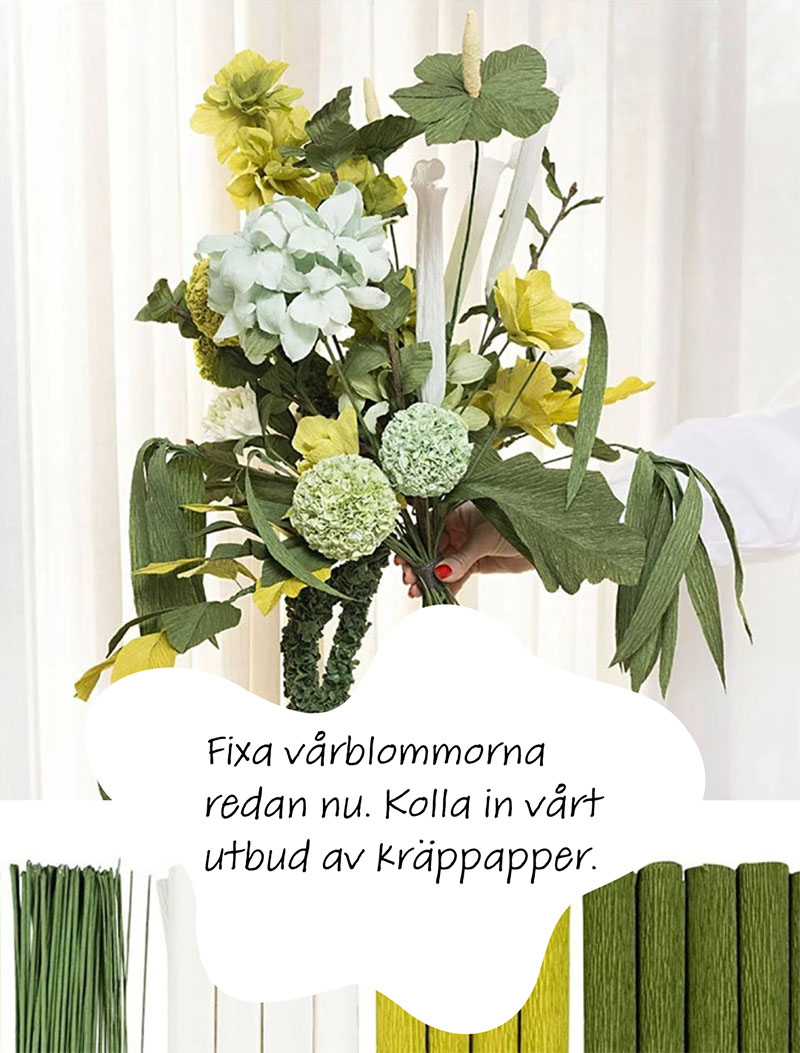 Blombukett skapade med kräppapper. Blommorna går i vit och grön färg.